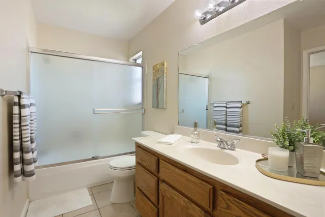 a bedroom with a bed and lamp on the table