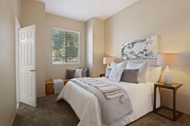 a bedroom with furniture and a window