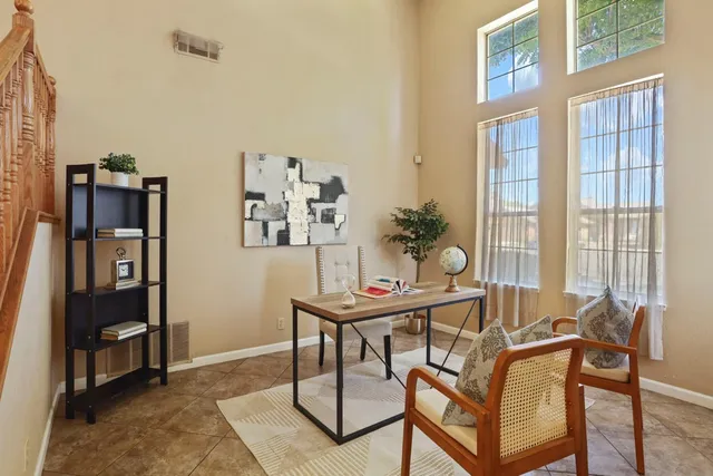 a view of a workspace with furniture and a window
