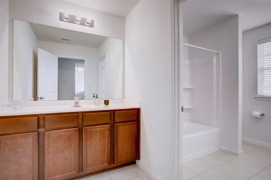 1303 Emerald Stone Drive Rosharon, TX 77583 - Photo 20 of 25 Spacious upstairs full bathroom featuring generous counter space and functional design.