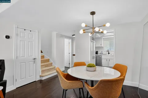 a view of a dining room with a table and chairs