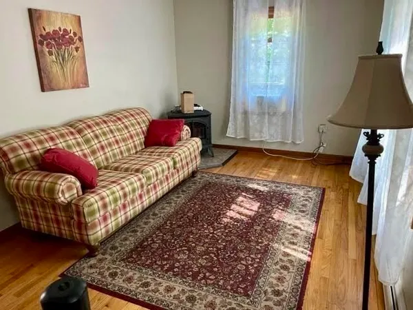 a bedroom with a bed and a lamp on the dresser