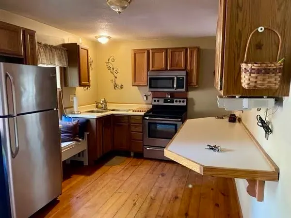 a kitchen with stainless steel appliances a stove refrigerator sink and microwave
