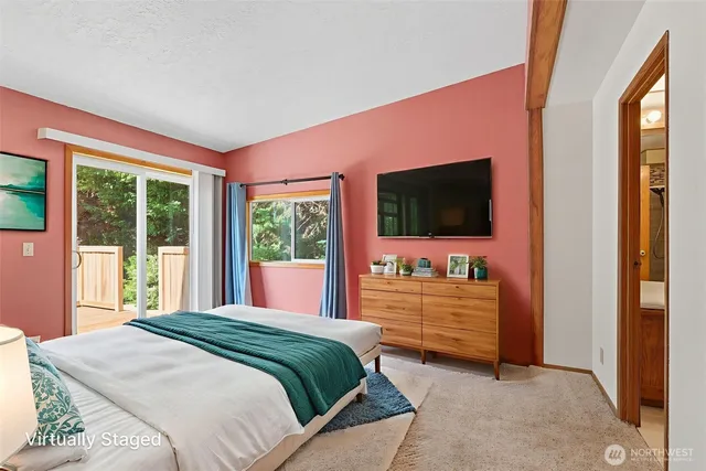 a bedroom with a bed and flat screen tv