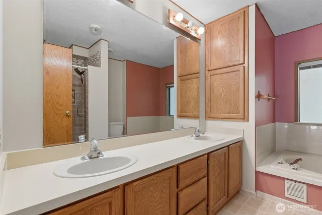 a bathroom with a sink double vanity and a mirror
