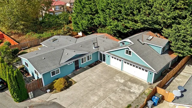 an aerial view of a house with a yard and balcony