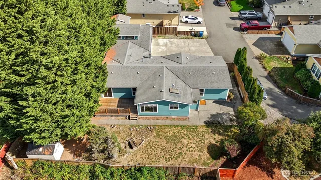 an aerial view of a house with a yard