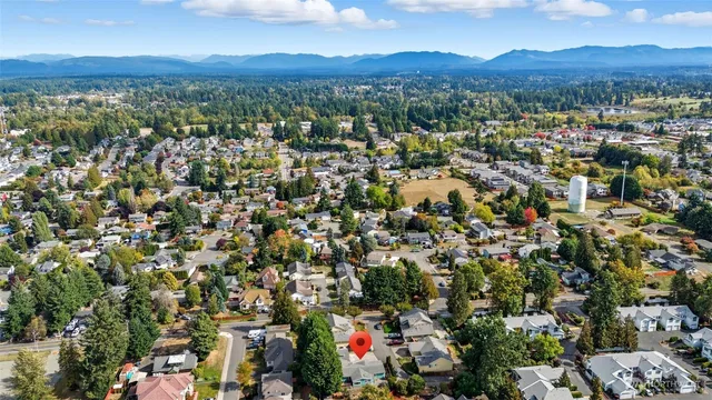 an aerial view of residential houses with outdoor space and ocean view