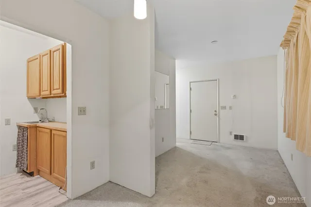 a view of a livingroom with wooden floor and cabinet