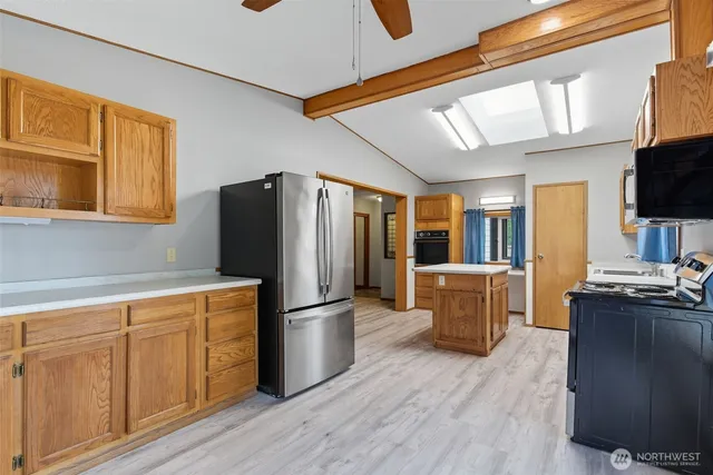 a kitchen with wooden cabinets and stainless steel appliances