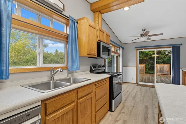 a kitchen that has a sink and a large window