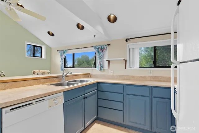 a kitchen with a sink and large window