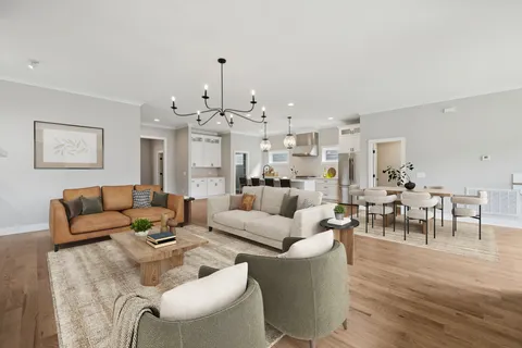 a living room with furniture kitchen view and a dining table