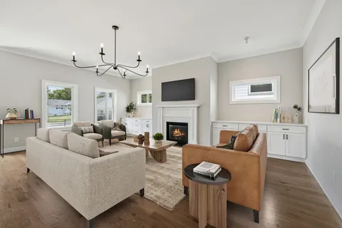 a living room with furniture a fireplace and a flat screen tv