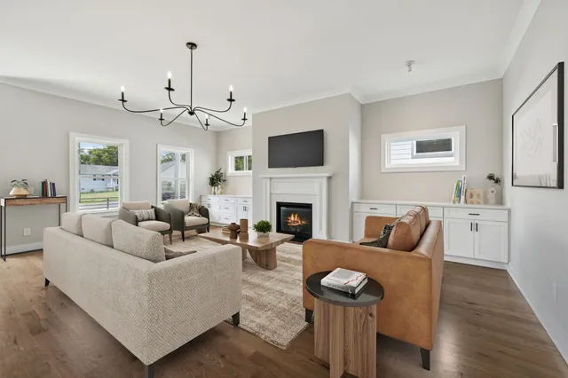 a living room with furniture a fireplace and a flat screen tv
