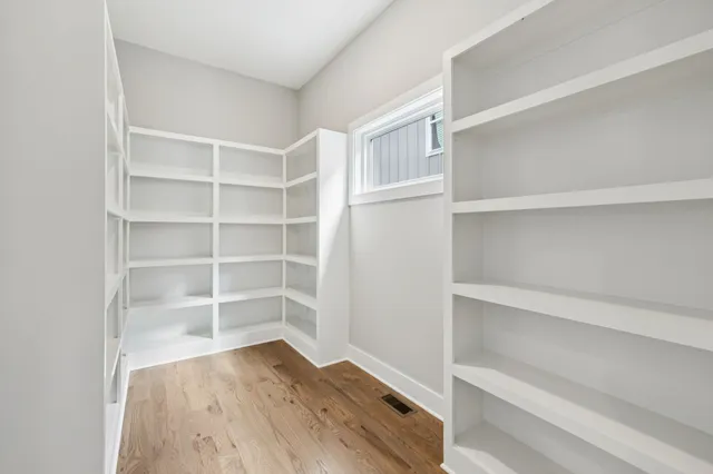 a view of walk in closet with empty racks
