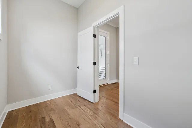 a view of a hallway with wooden floor