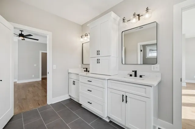 a bathroom with a double vanity sink mirror and