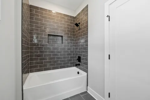 a spacious bathroom with a double vanity sink a mirror and a