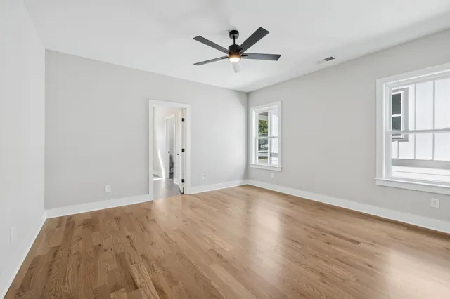a view of an empty room and wooden floor