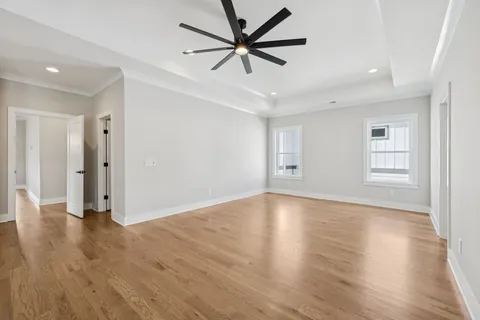 a bedroom with a bed and ceiling fan