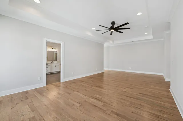 a spacious bathroom with a shower a sink and mirror