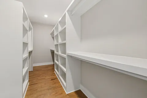 a view of a balcony with wooden chairs