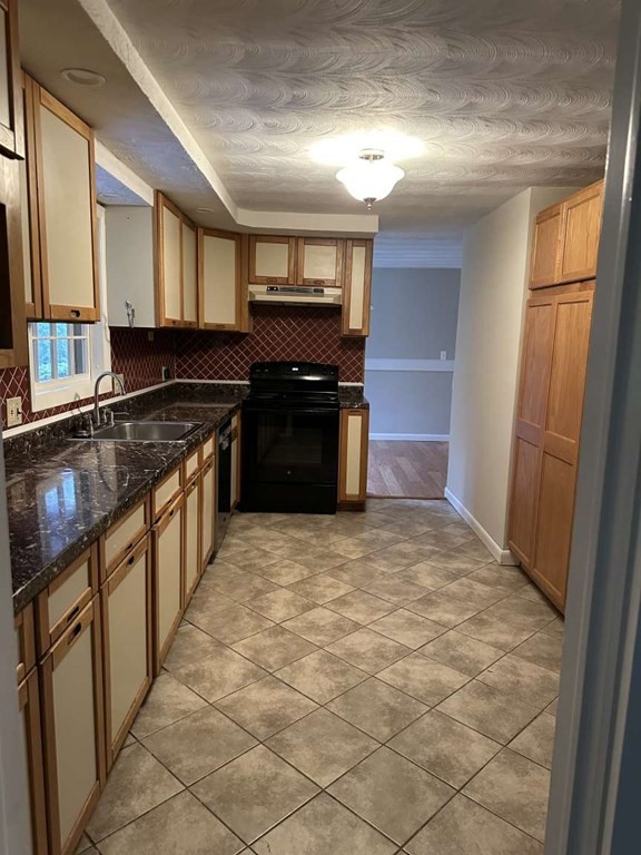 19 Merrill Drive Framingham, MA 01701 - Photo 13 of 18 a kitchen with stainless steel appliances granite countertop a stove a sink and a refrigerator