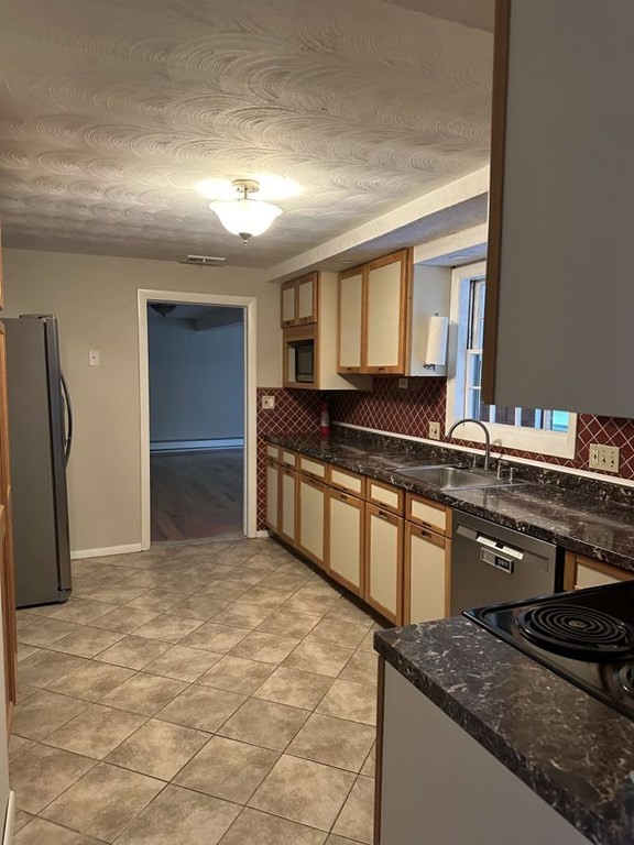19 Merrill Drive Framingham, MA 01701 - Photo 14 of 18 a kitchen with granite countertop a stove and a refrigerator