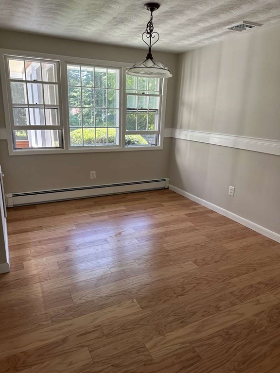 19 Merrill Drive Framingham, MA 01701 - Photo 3 of 18 a view of an empty room with wooden floor and a window