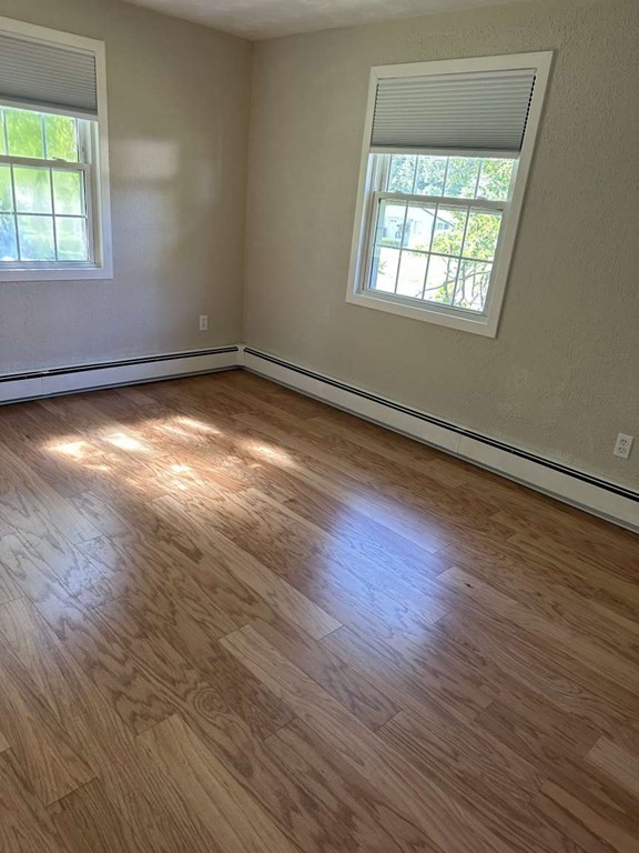 19 Merrill Drive Framingham, MA 01701 - Photo 4 of 18 an empty room with wooden floor and windows