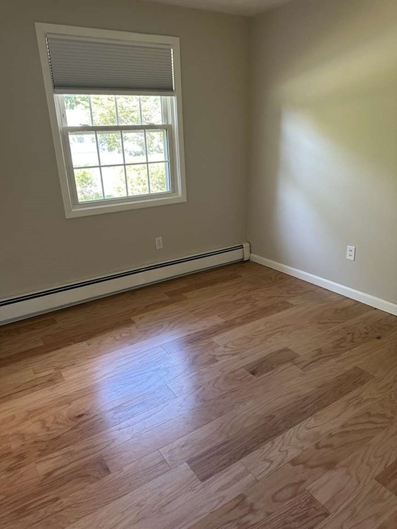 19 Merrill Drive Framingham, MA 01701 - Photo 8 of 18 an empty room with wooden floor and windows