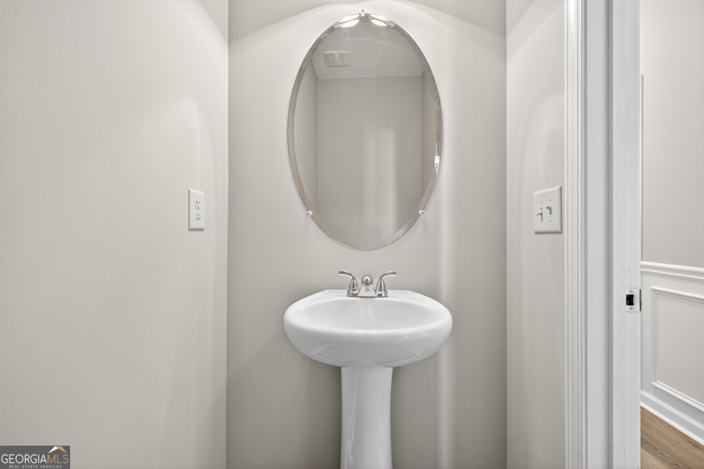 1734 Snapping Court Winder, GA 30680 - Photo 13 of 35 a bathroom with a sink and a mirror