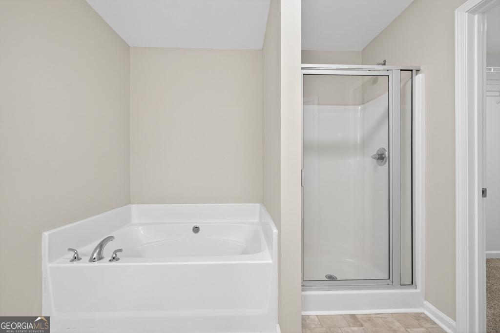 1734 Snapping Court Winder, GA 30680 - Photo 20 of 35 a white bath tub sitting next to a shower