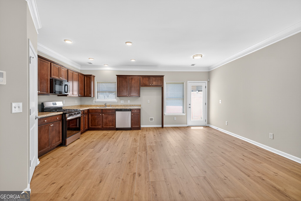 1734 Snapping Court Winder, GA 30680 - Photo 2 of 35 a large kitchen with stainless steel appliances granite countertop a large counter top a sink and a stove