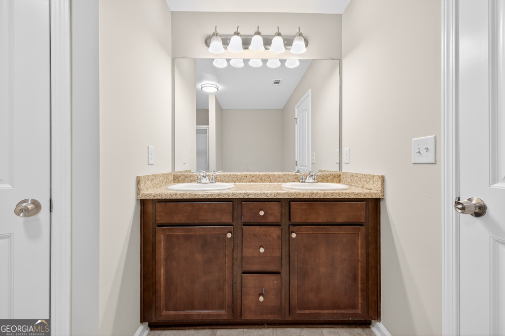 1734 Snapping Court Winder, GA 30680 - Photo 21 of 35 a bathroom with a sink and a mirror