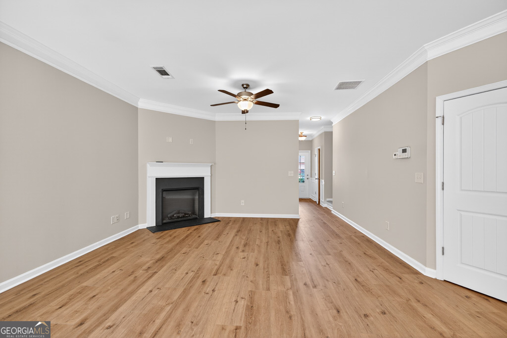 1734 Snapping Court Winder, GA 30680 - Photo 5 of 35 wooden floor in an empty room with a fireplace