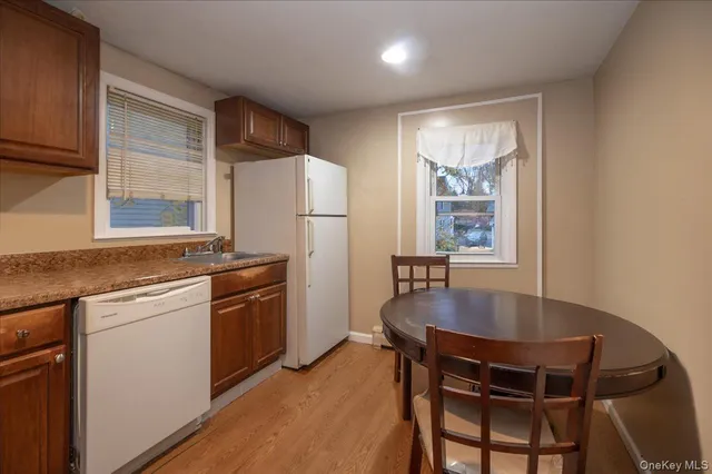 a kitchen with granite countertop a sink stove and cabinets