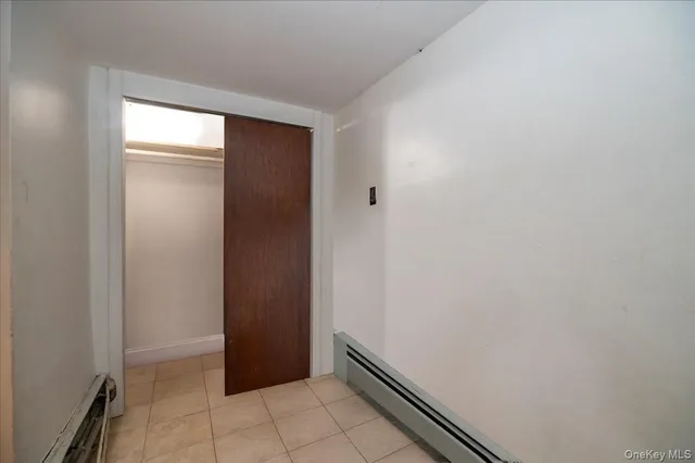 a bedroom with a bed and a night stand