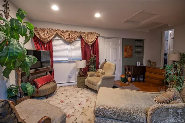 a living room with furniture and a potted plant