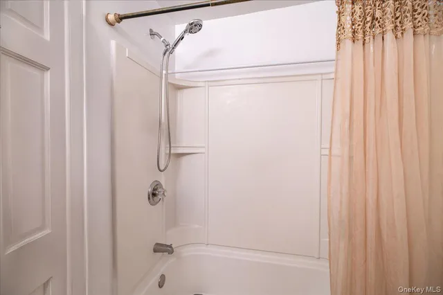 a bedroom with furniture and a large window