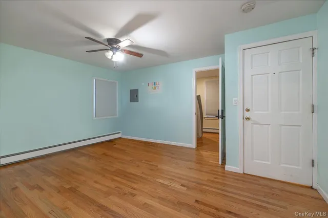 a view of hallway with wooden floor