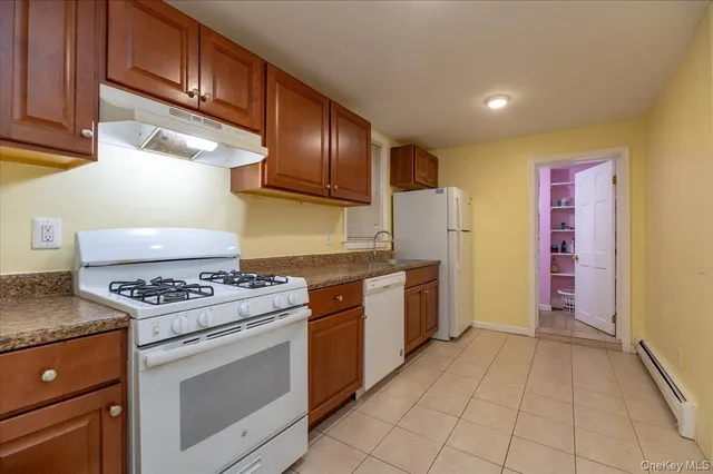 a kitchen with a sink cabinets and window