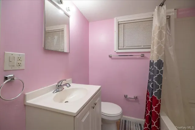 a view of room with window and wooden floor