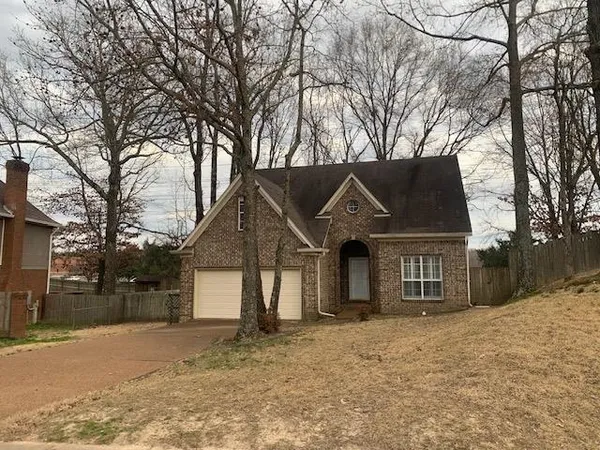 a front view of a house with a yard covered in snow