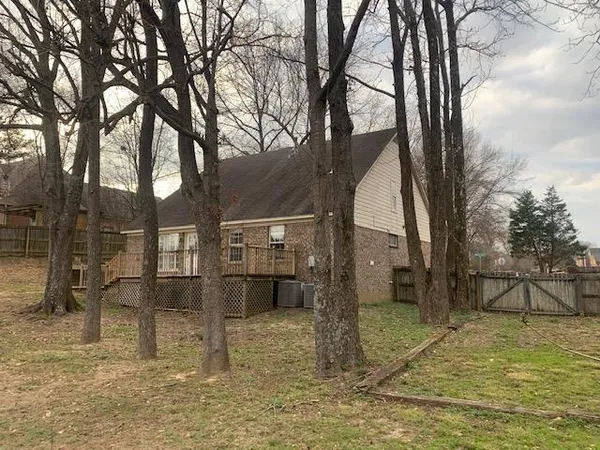 a kitchen with granite countertop white cabinets and black appliances