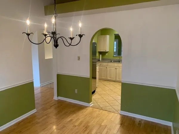 a view of an empty room with a fireplace and a window