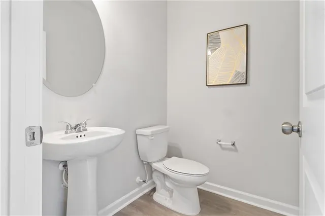 a bathroom with a sink mirror and toilet