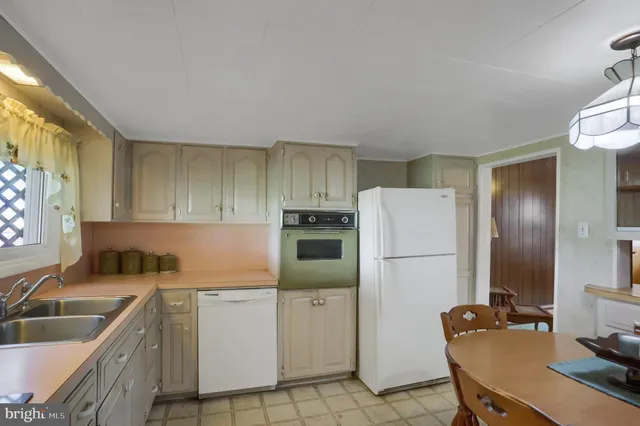 a kitchen with a refrigerator sink and stove