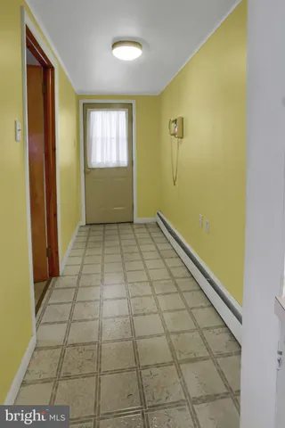 a view of a livingroom with furniture and an entryway